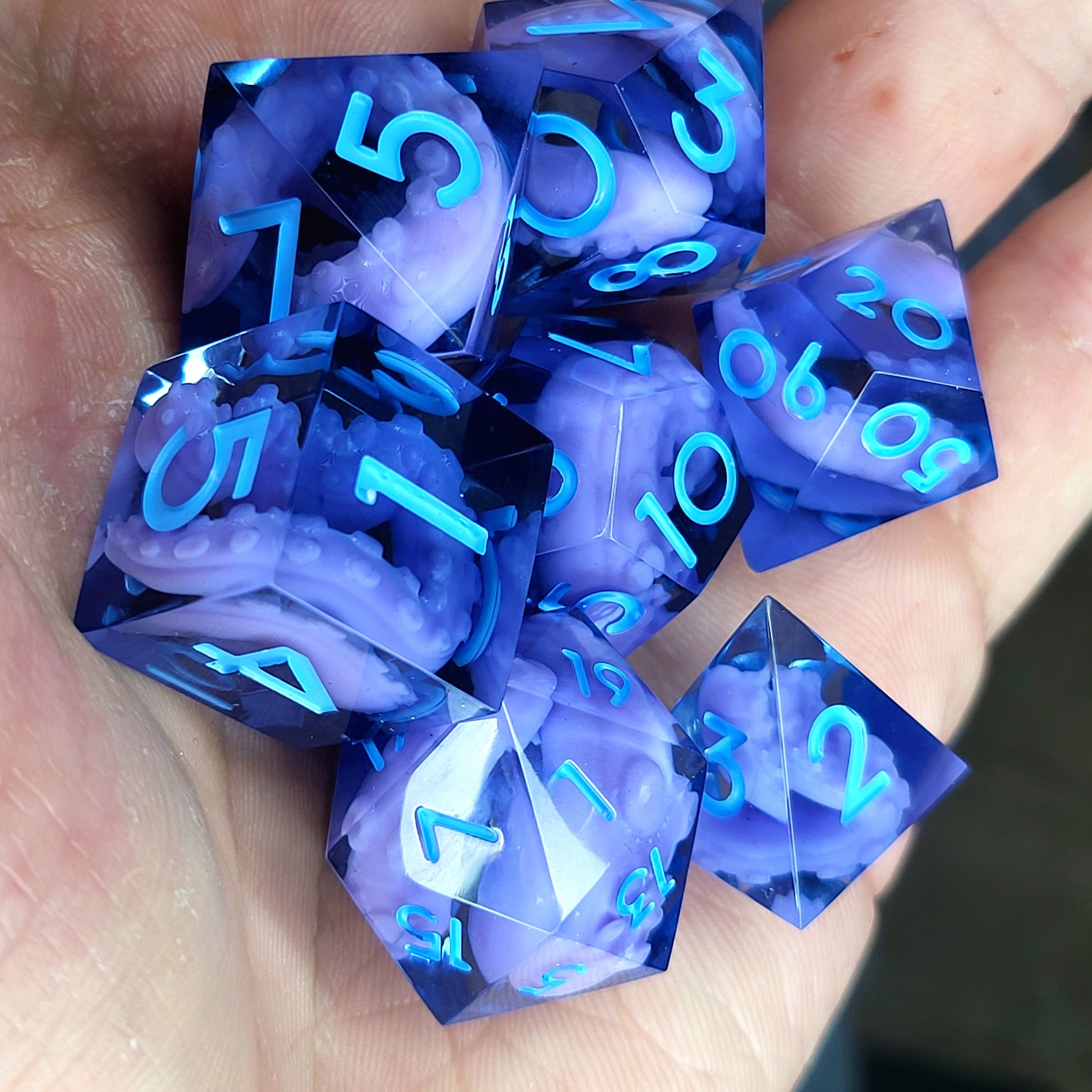 Dice set with purple tentacles inside and blue numbers for play dnd , dungeons and dragons and Call of Cthulhu