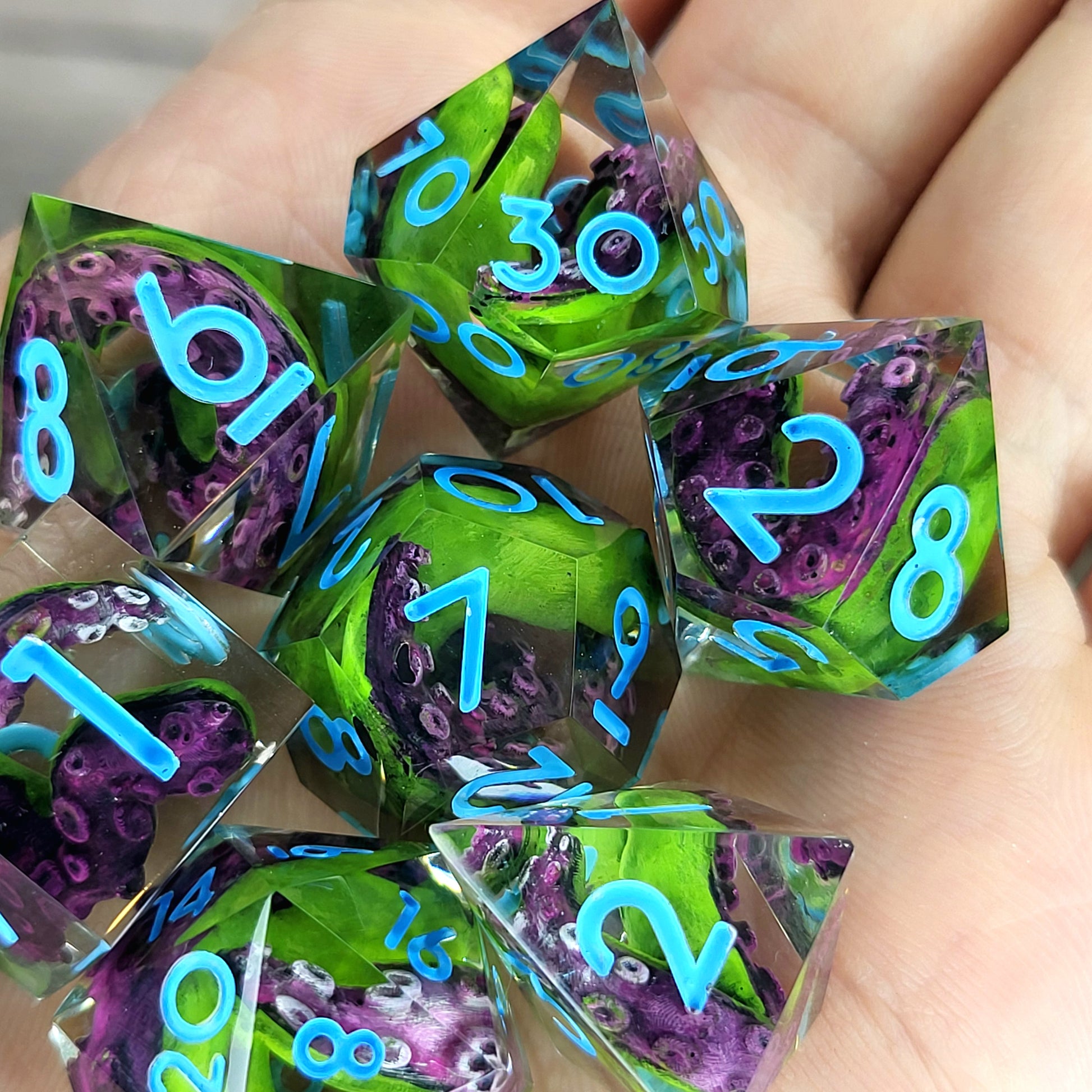 Dice set with green and purple tentacles inside and blue numbers for play dnd , dungeons and dragons
