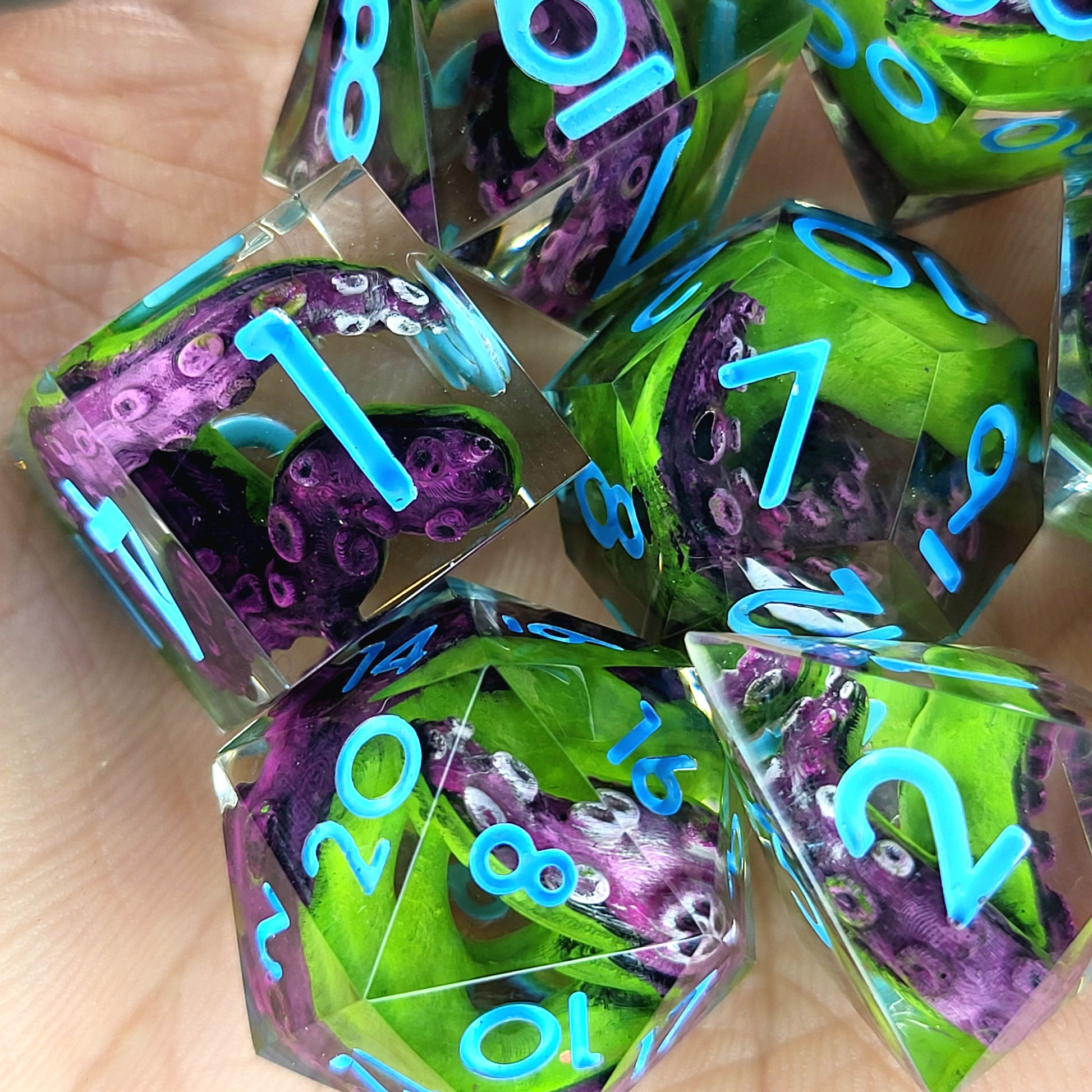Dice set with green and purple tentacles inside and blue numbers for play dnd , dungeons and dragons