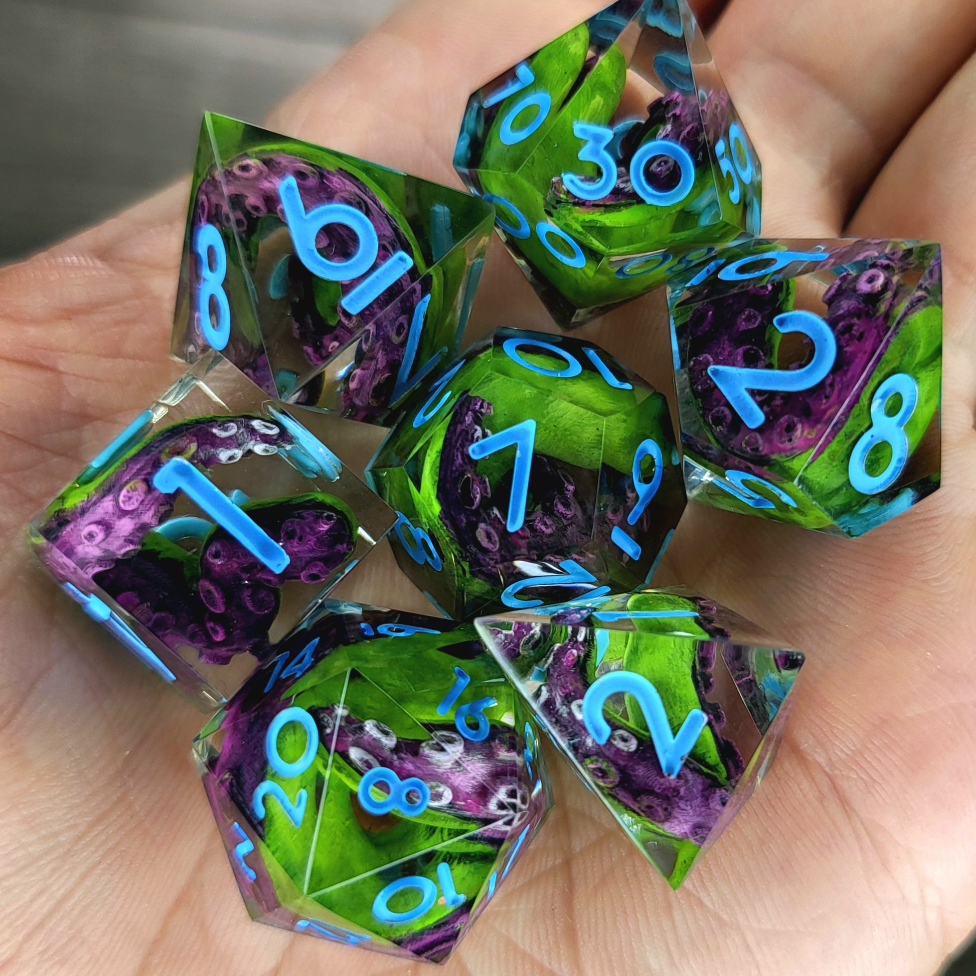 Dice set with green and purple tentacles inside and blue numbers for play dnd , dungeons and dragons