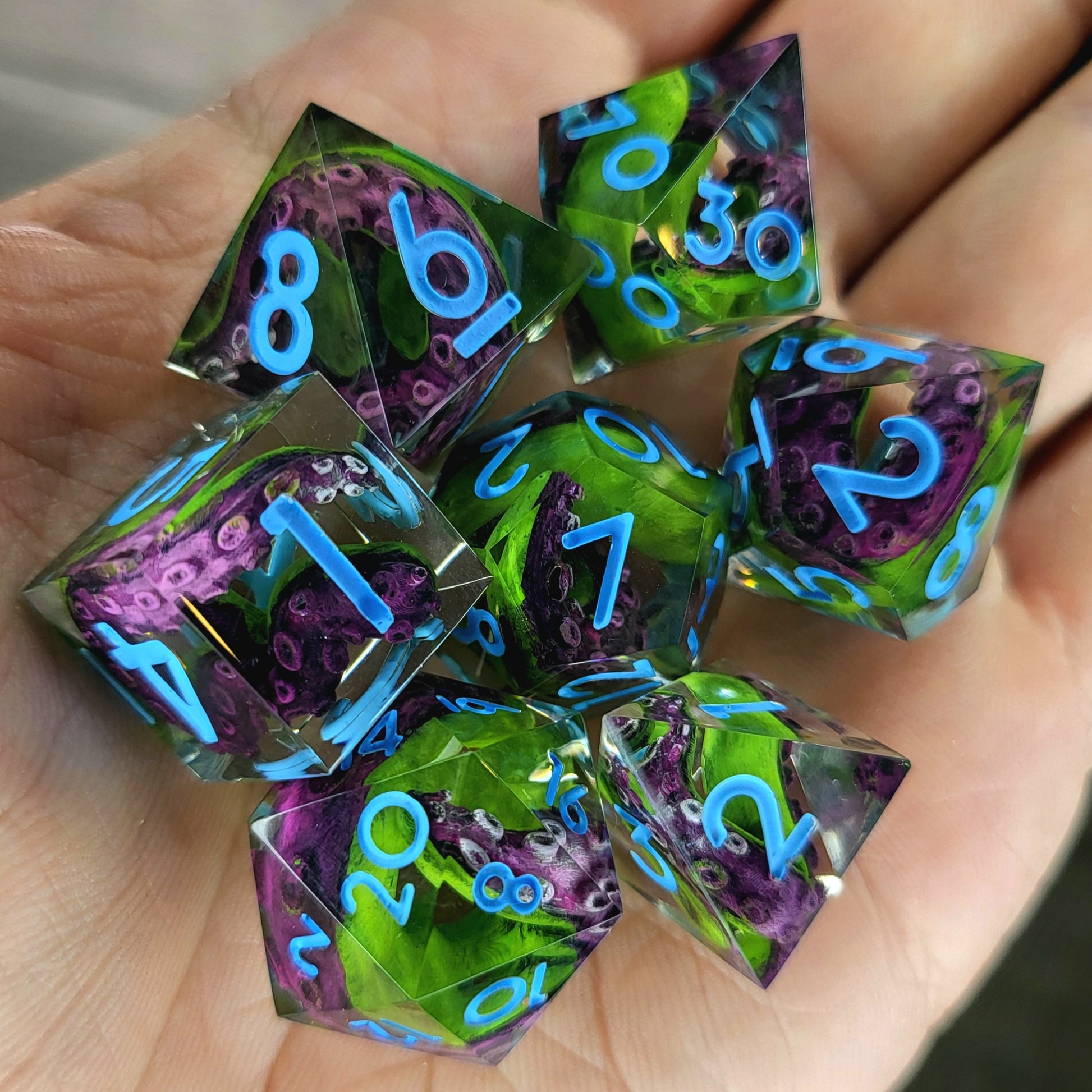 Dice set with green and purple tentacles inside and blue numbers for play dnd , dungeons and dragons