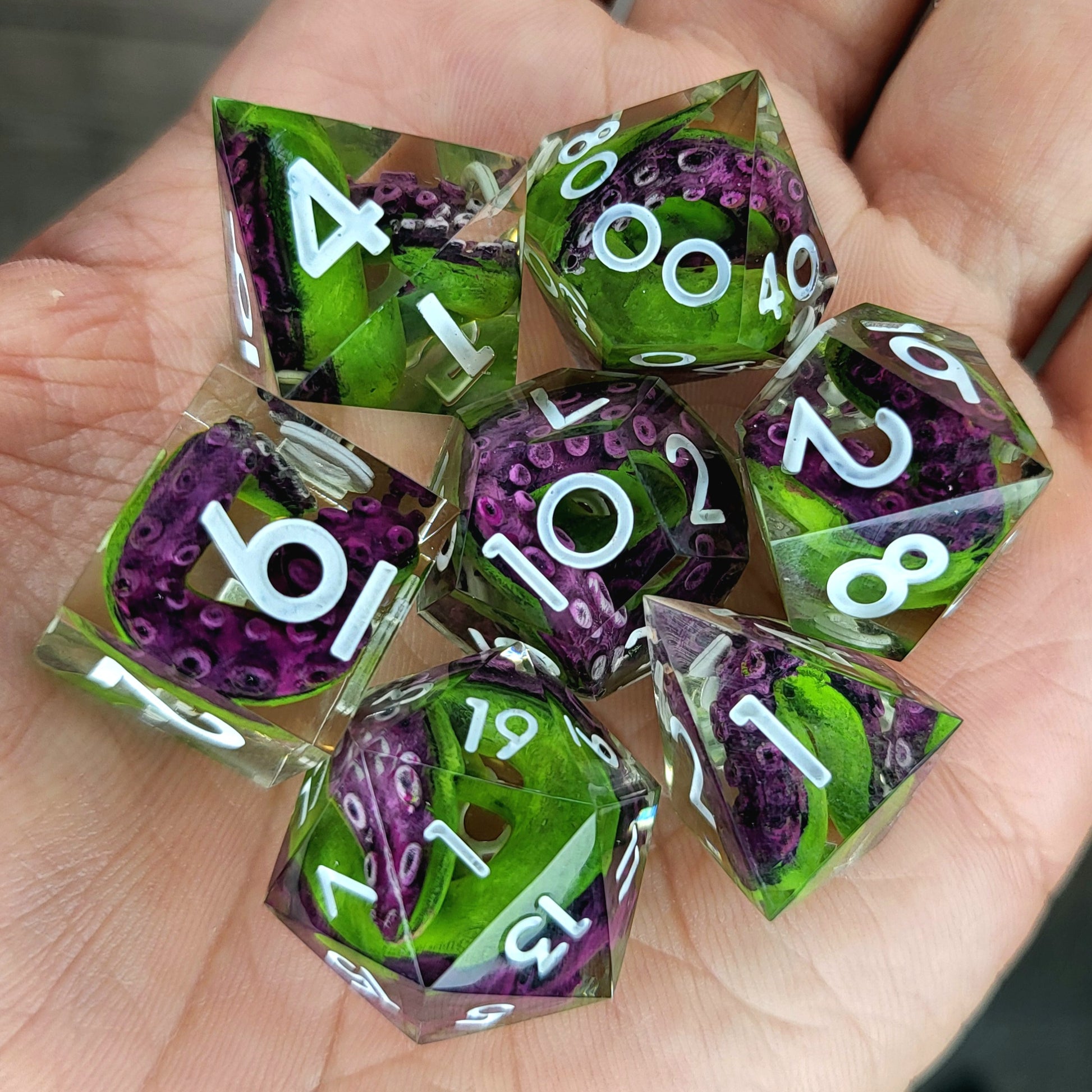 Dice set with green tentacles inside and white numbers for play dnd , dungeons and dragons
