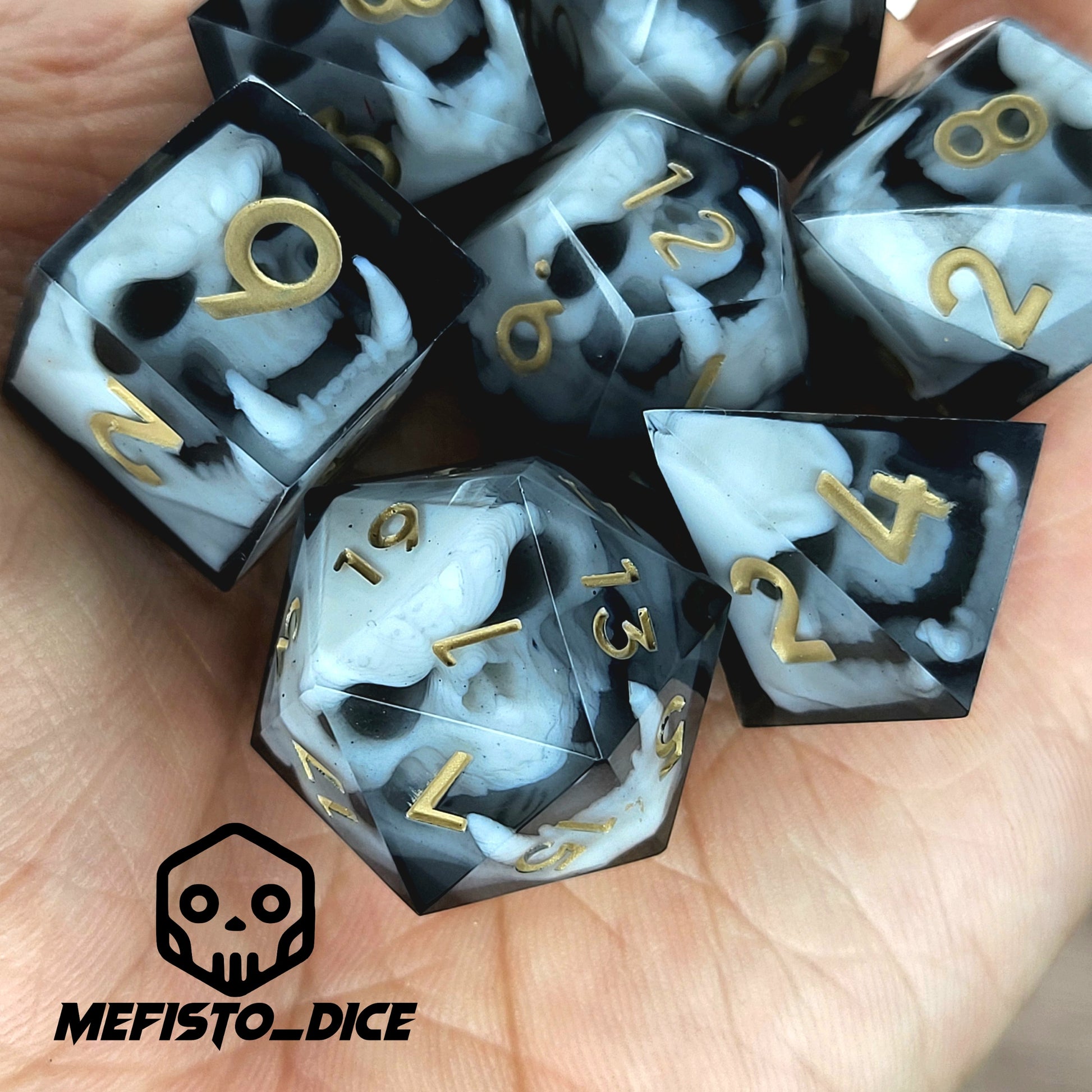 Black and white resin dice set featuring detailed orc skulls with gold numbers, fantasy RPG dice for DnD and tabletop roleplaying games