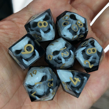 Black and white resin dice set featuring detailed orc skulls with gold numbers, fantasy RPG dice for DnD and tabletop roleplaying games