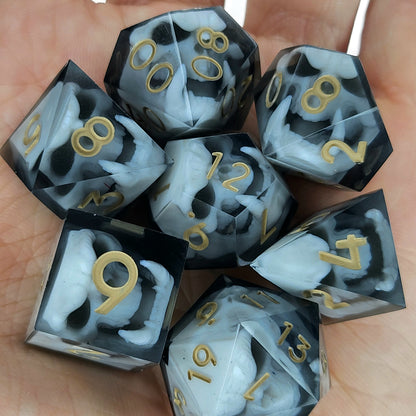 Black and white resin dice set featuring detailed orc skulls with gold numbers, fantasy RPG dice for DnD and tabletop roleplaying games