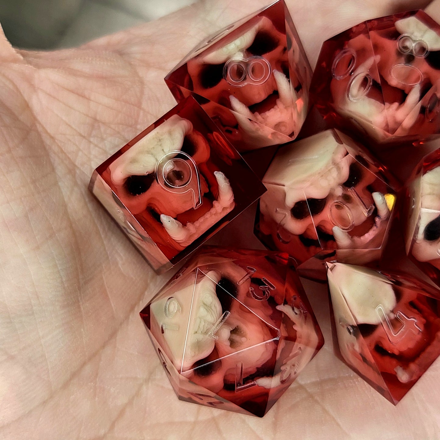 Red resin DnD dice set with detailed orc skulls inside