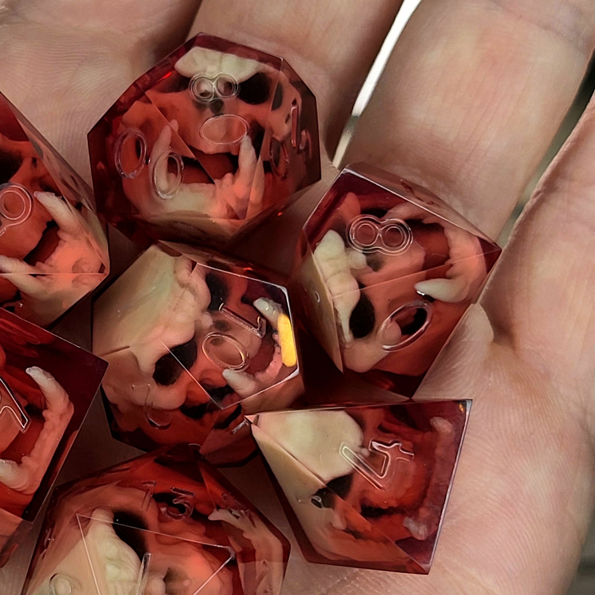 Red resin DnD dice set with detailed orc skulls inside