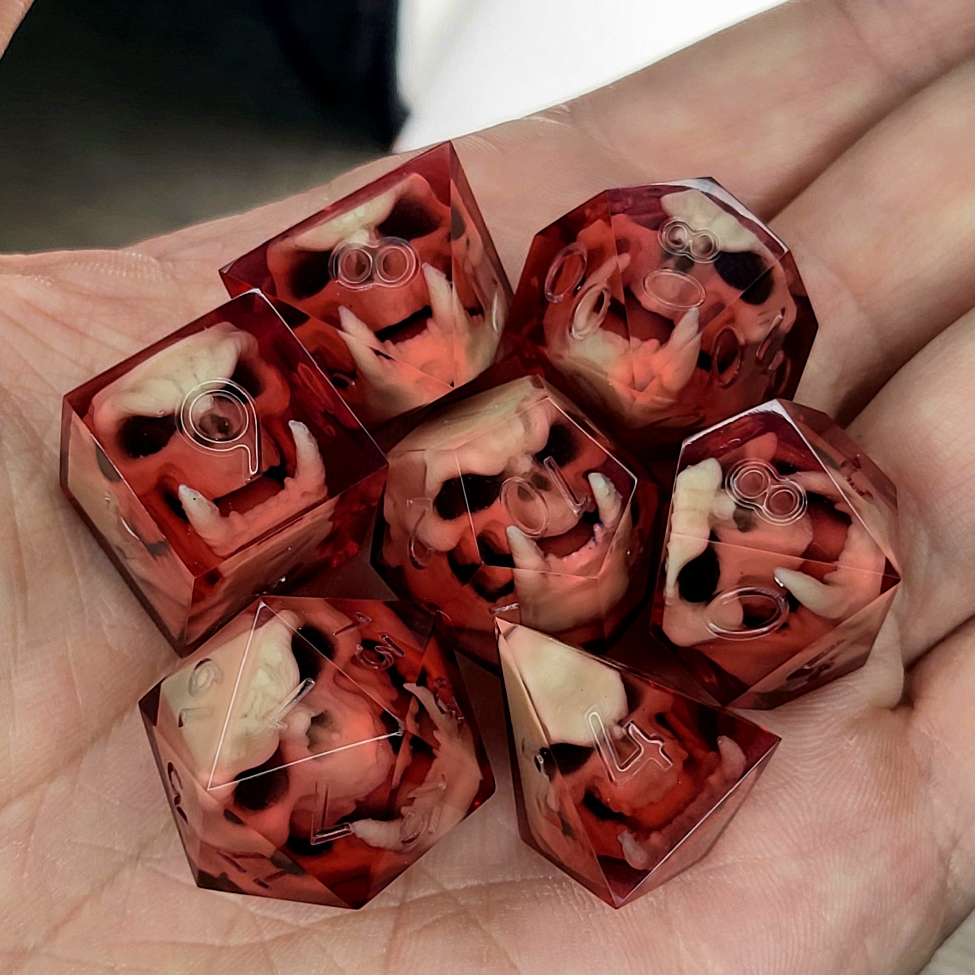 Red resin DnD dice set with detailed orc skulls inside