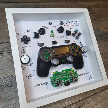 Shadow Box 10x10 with wood frame and polycarbonate glass for wall and Tabletop containing a disassembled controller for Playstation and Nintendo