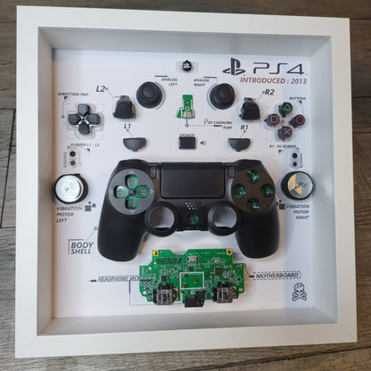 Shadow Box 10x10 with wood frame and polycarbonate glass for wall and Tabletop containing a disassembled controller for Playstation and Nintendo