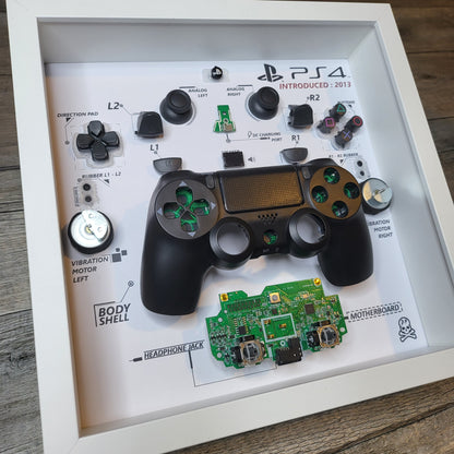 Shadow Box 10x10 with wood frame and polycarbonate glass for wall and Tabletop containing a disassembled controller for Playstation and Nintendo