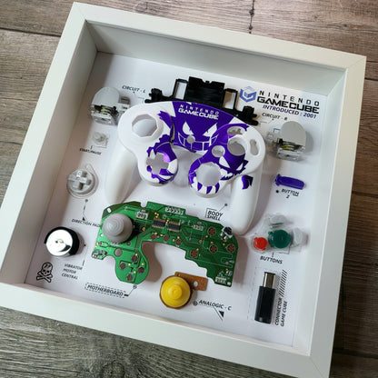 Shadow Box 10x10 with wood frame and polycarbonate glass for wall and Tabletop containing a disassembled controller for Playstation and Nintendo