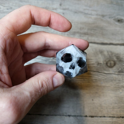 D20 dice in 33 mm format with skull inside for role-playing games for Dungeons and Dragons