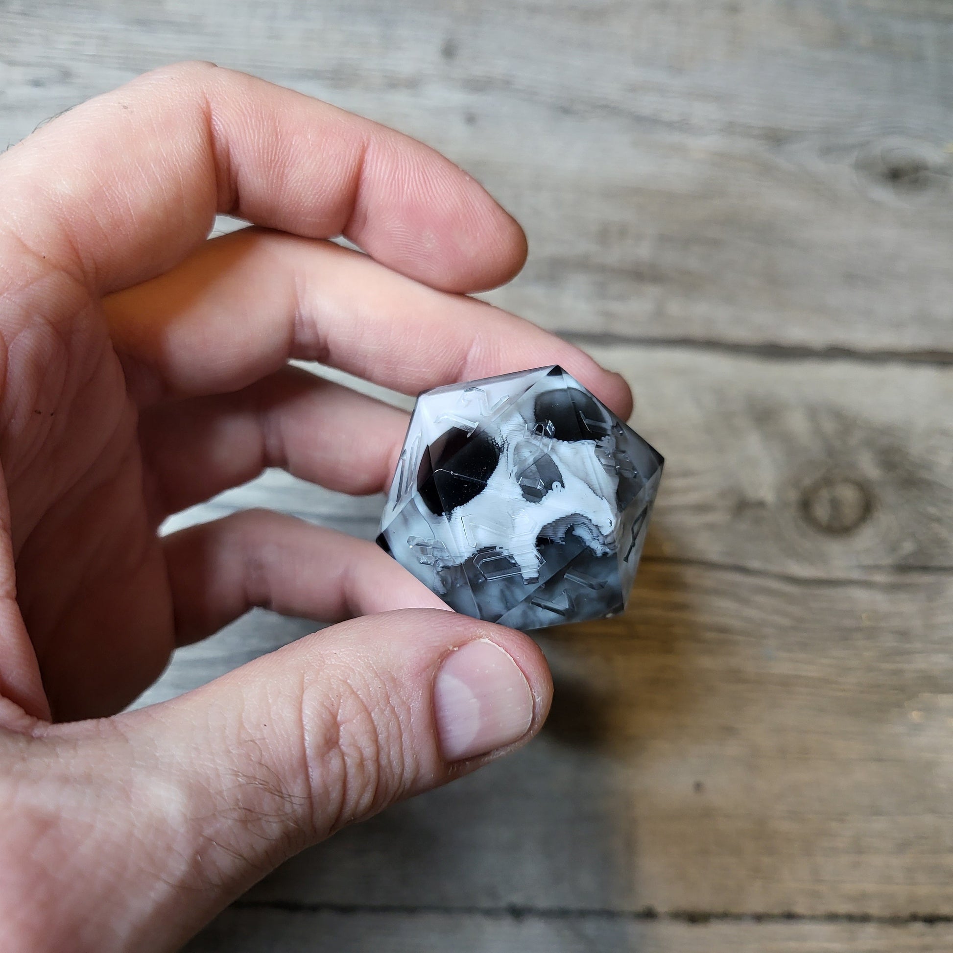 D20 dice in 33 mm format with skull inside for role-playing games for Dungeons and Dragons