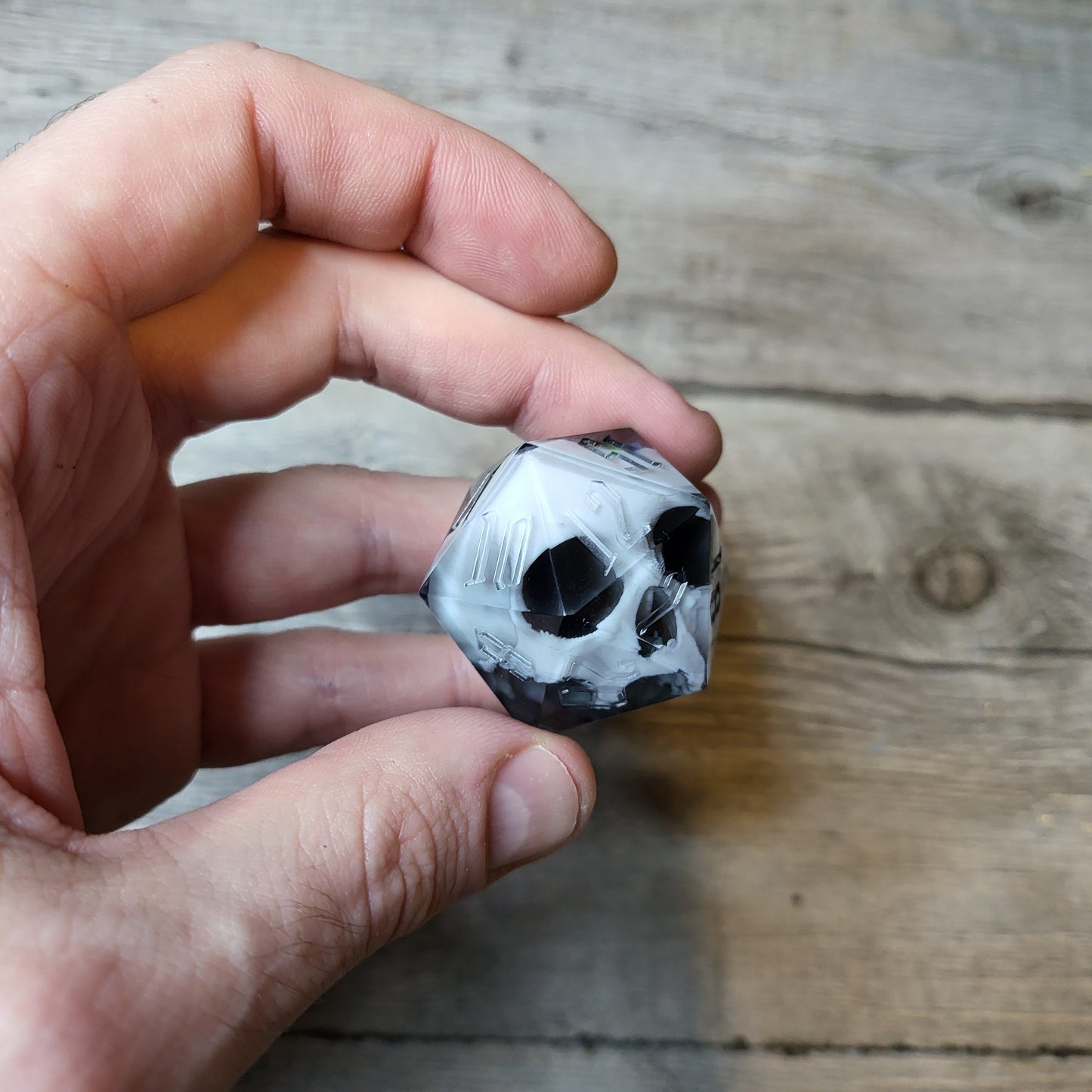 D20 dice in 33 mm format with skull inside for role-playing games for Dungeons and Dragons