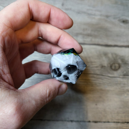 D20 dice in 33 mm format with skull inside for role-playing games for Dungeons and Dragons