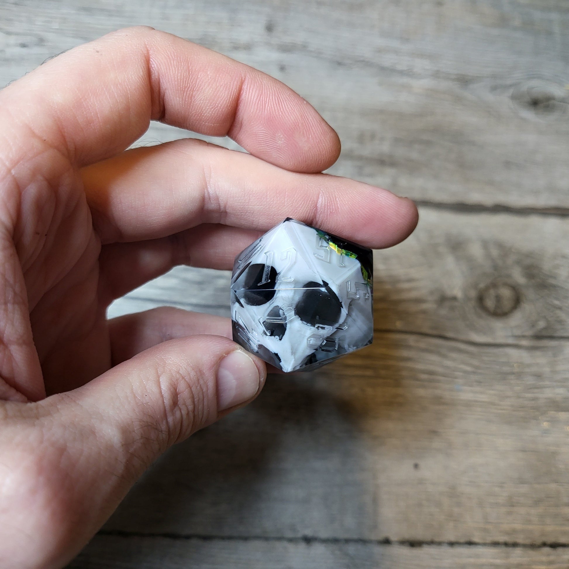 D20 dice in 33 mm format with skull inside for role-playing games for Dungeons and Dragons