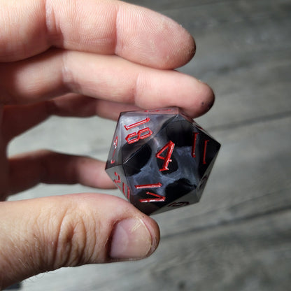 D20 dice in 33 mm format with skull inside for role-playing games for Dungeons and Dragons