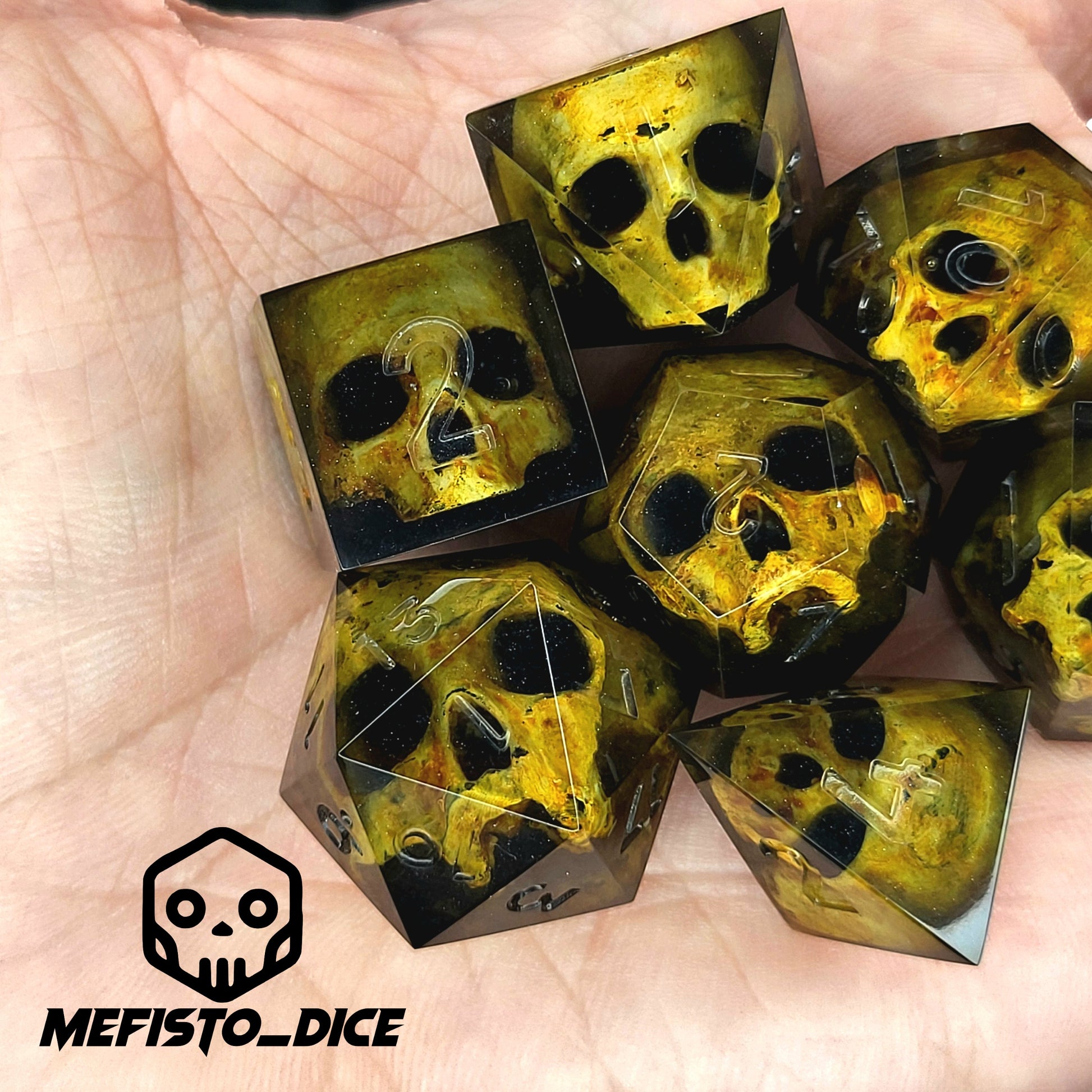 Black resin DnD dice set with detailed yellow skulls inside