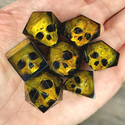 Black resin DnD dice set with detailed yellow skulls inside