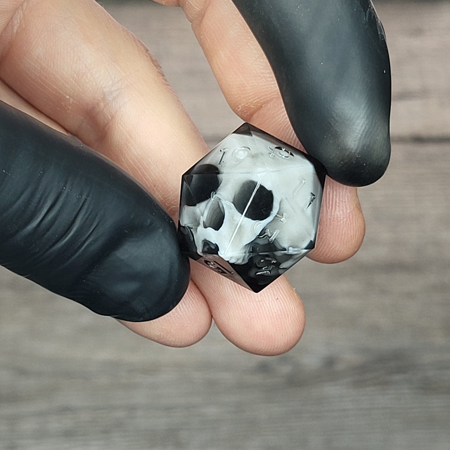 d20 dice for playing Dungeons and Dragons with a white skull and black resin