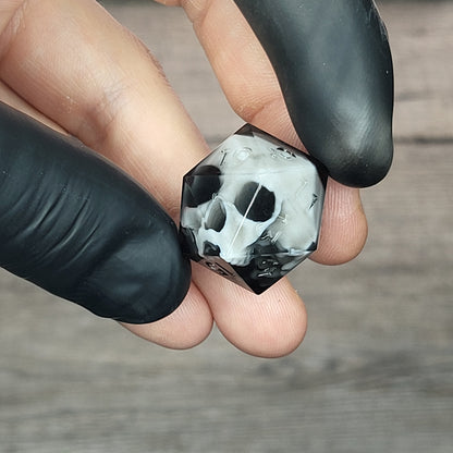 d20 dice for playing Dungeons and Dragons with a white skull and black resin
