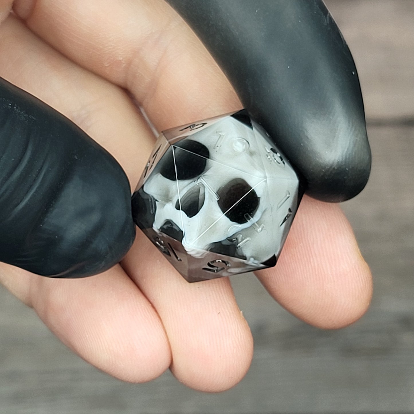 d20 dice for playing Dungeons and Dragons with a white skull and black resin