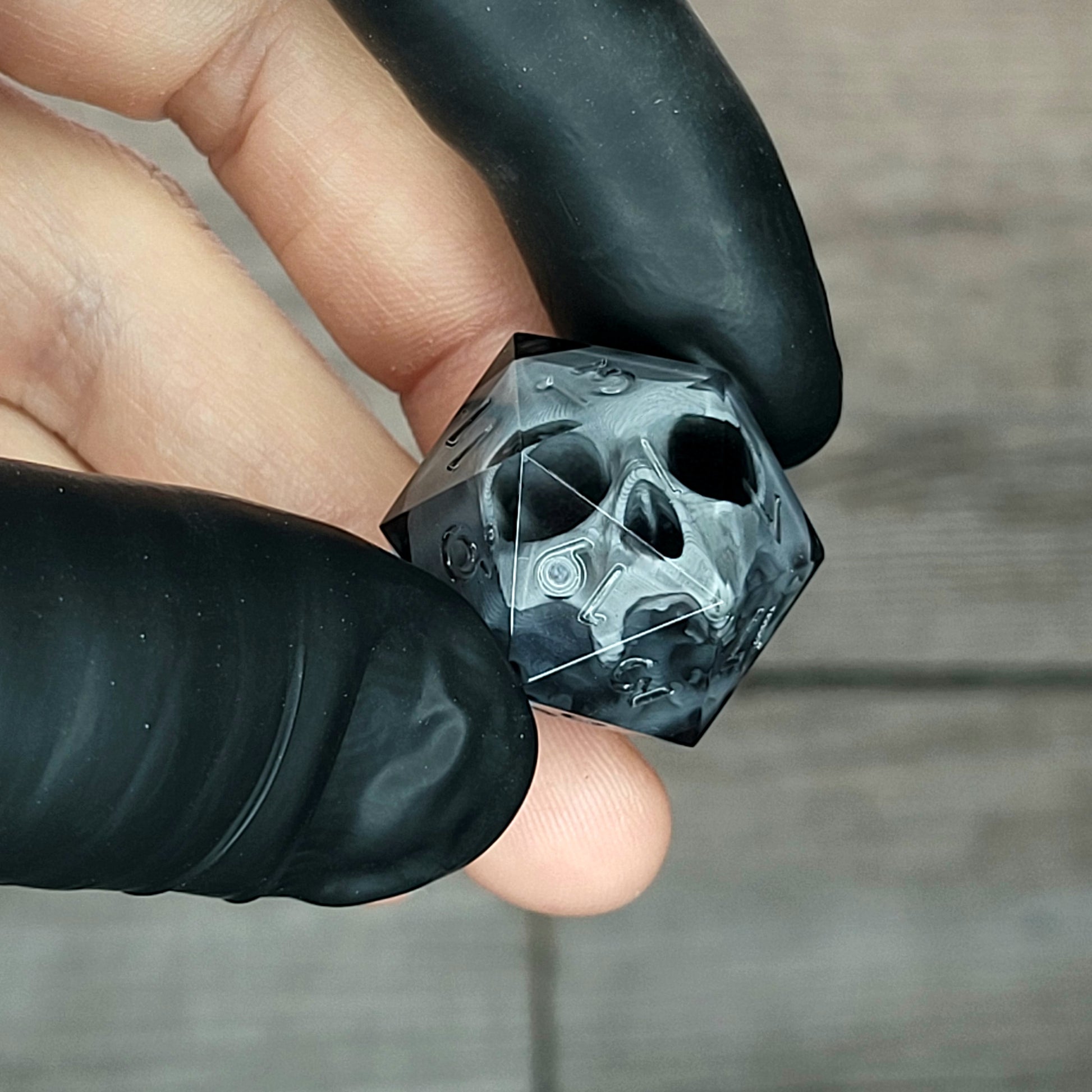 Dice D20 with grey skull inside for role playing for Dungeons and Dragons