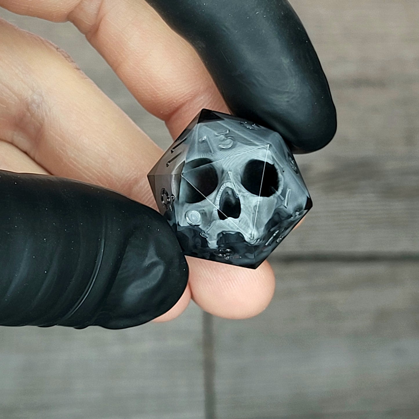 Dice D20 with grey skull inside for role playing for Dungeons and Dragons