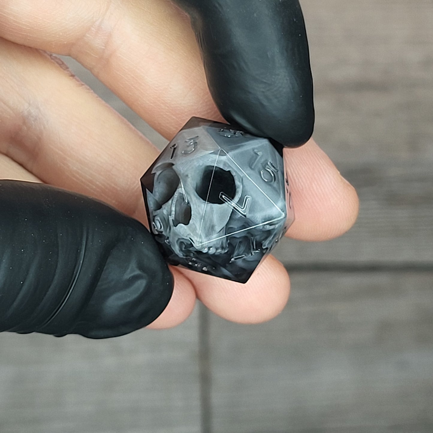 Dice D20 with grey skull inside for role playing for Dungeons and Dragons