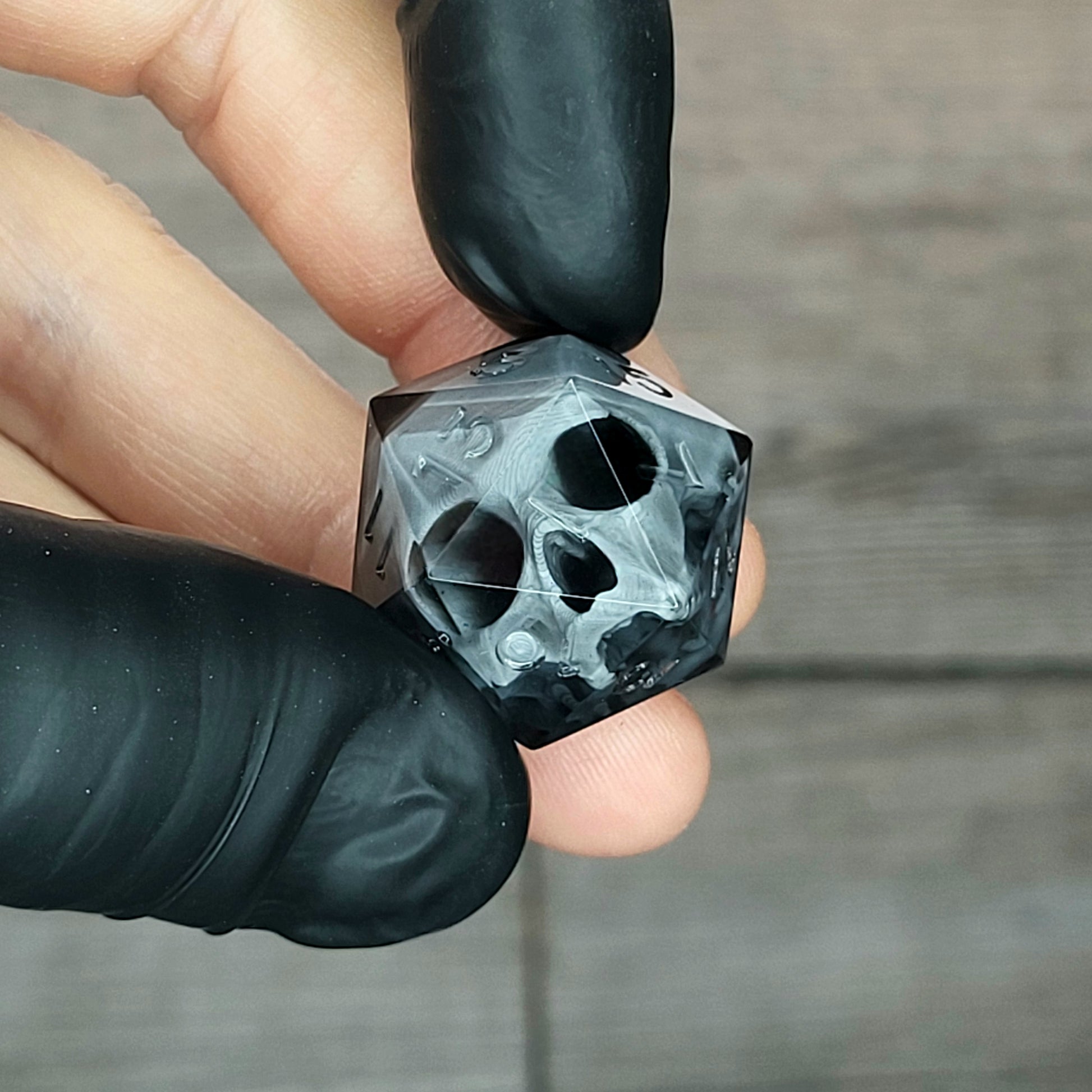 Dice D20 with grey skull inside for role playing for Dungeons and Dragons