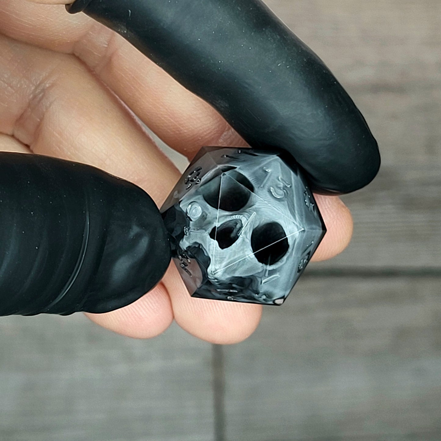 Dice D20 with grey skull inside for role playing for Dungeons and Dragons