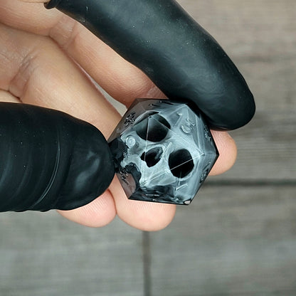 Dice D20 with grey skull inside for role playing for Dungeons and Dragons