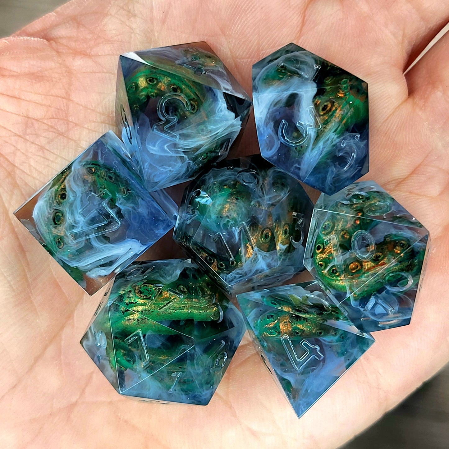 Clear resin DnD dice set with green and gold tentacles inside surrounded by white smoke effects