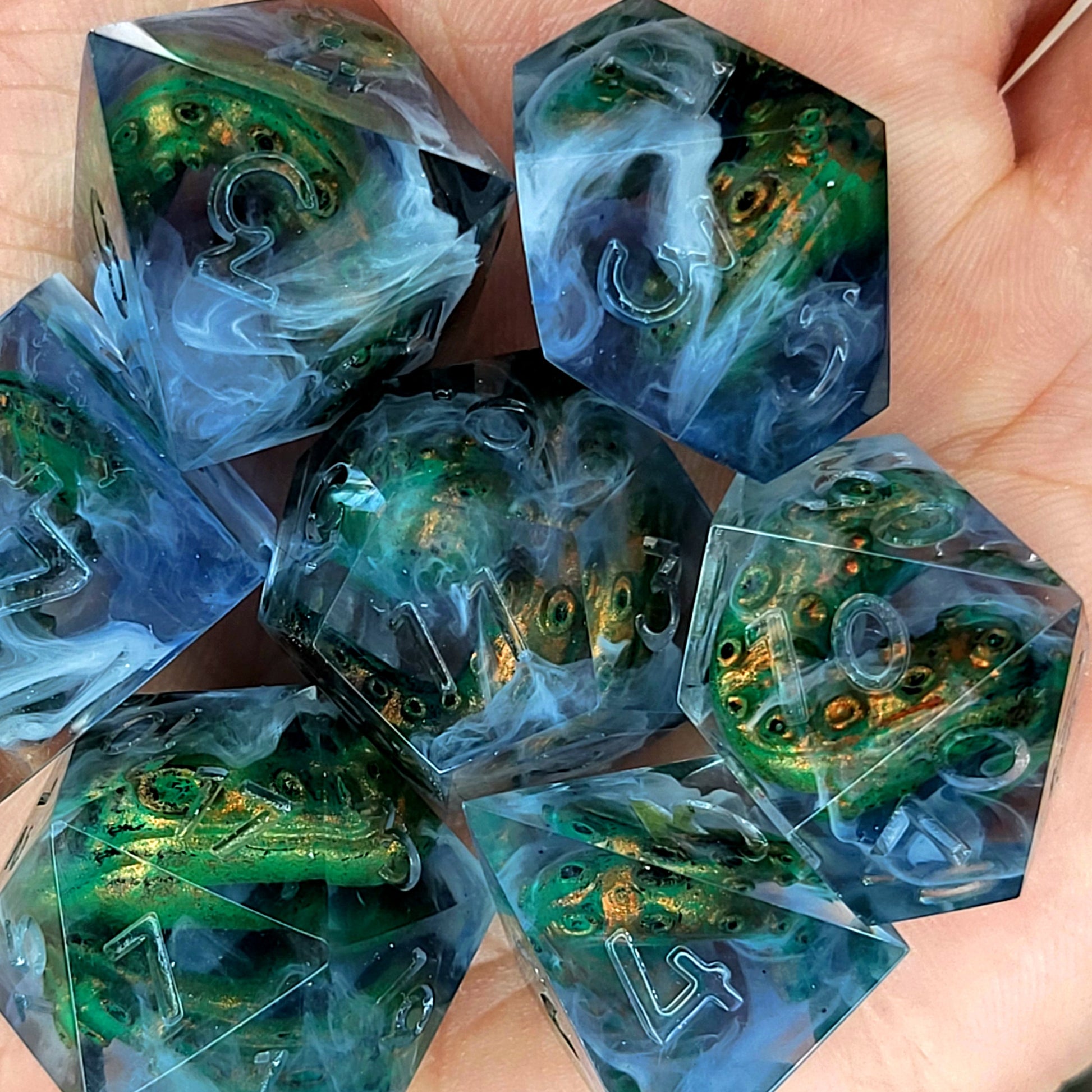 Clear resin DnD dice set with green and gold tentacles inside surrounded by white smoke effects