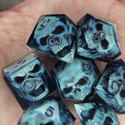 Close-up of black resin dice with mint-green undead zombie skulls and dark metallic silver numbers, handcrafted by Mefisto_Dice.