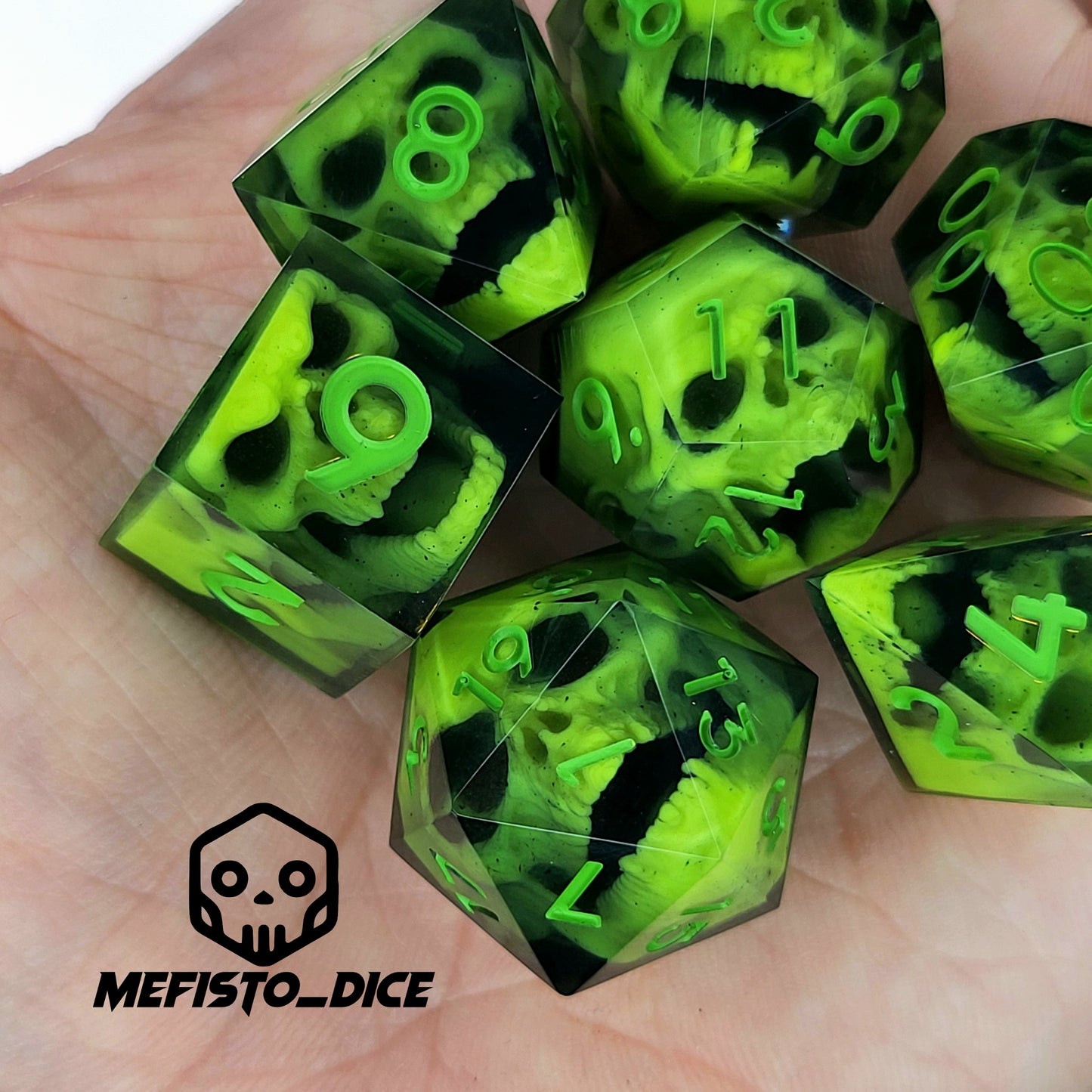 Close-up of black resin dice with neon-green undead zombie skulls and bright green numbers, handcrafted by Mefisto_Dice.