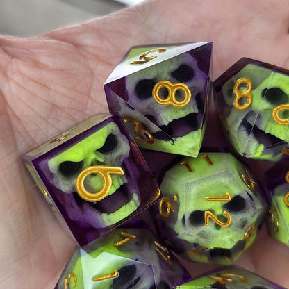 Close-up of purple resin dice with acid-green undead zombie skulls and gold numbers, handcrafted by Mefisto_Dice