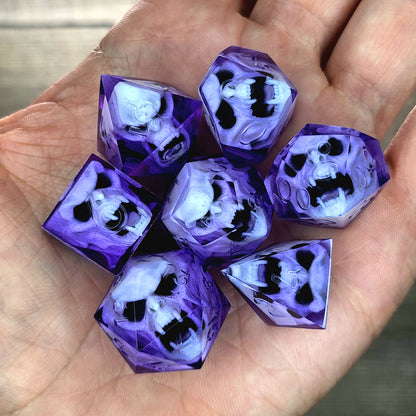 Purple resin DnD dice set with detailed white vampire skulls inside