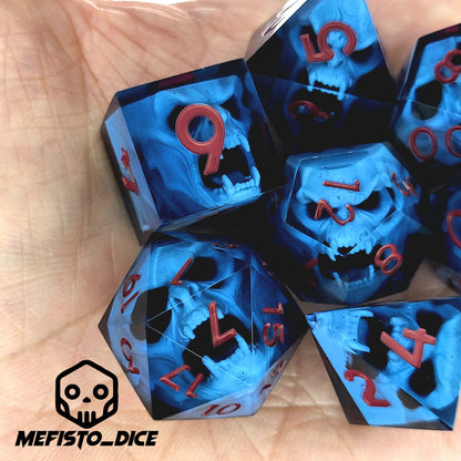 Blue resin DnD dice set with light blue skulls inside and red engraved numbers