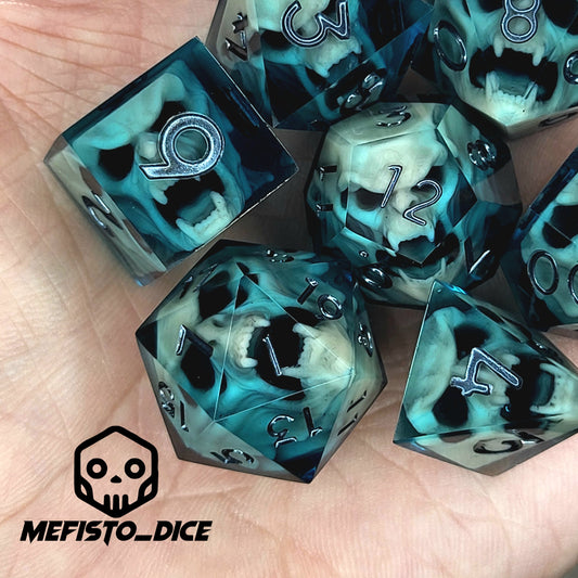 Teal and black resin DnD dice set with bone-colored skulls inside and metallic silver numbers