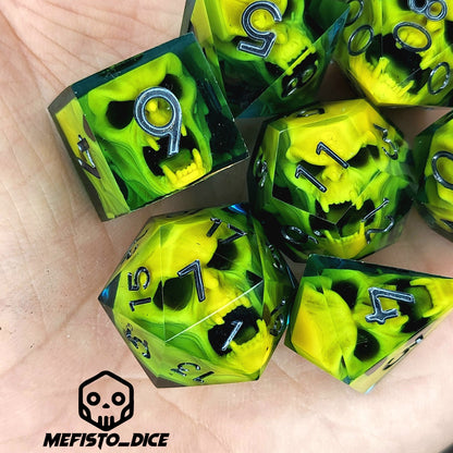 Blue resin DnD dice set with bright yellow skulls inside and silver engraved numbers