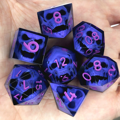 Close-up of black resin dice with purple zombie skulls inside and pink numbers, handcrafted by Mefisto_Dice.