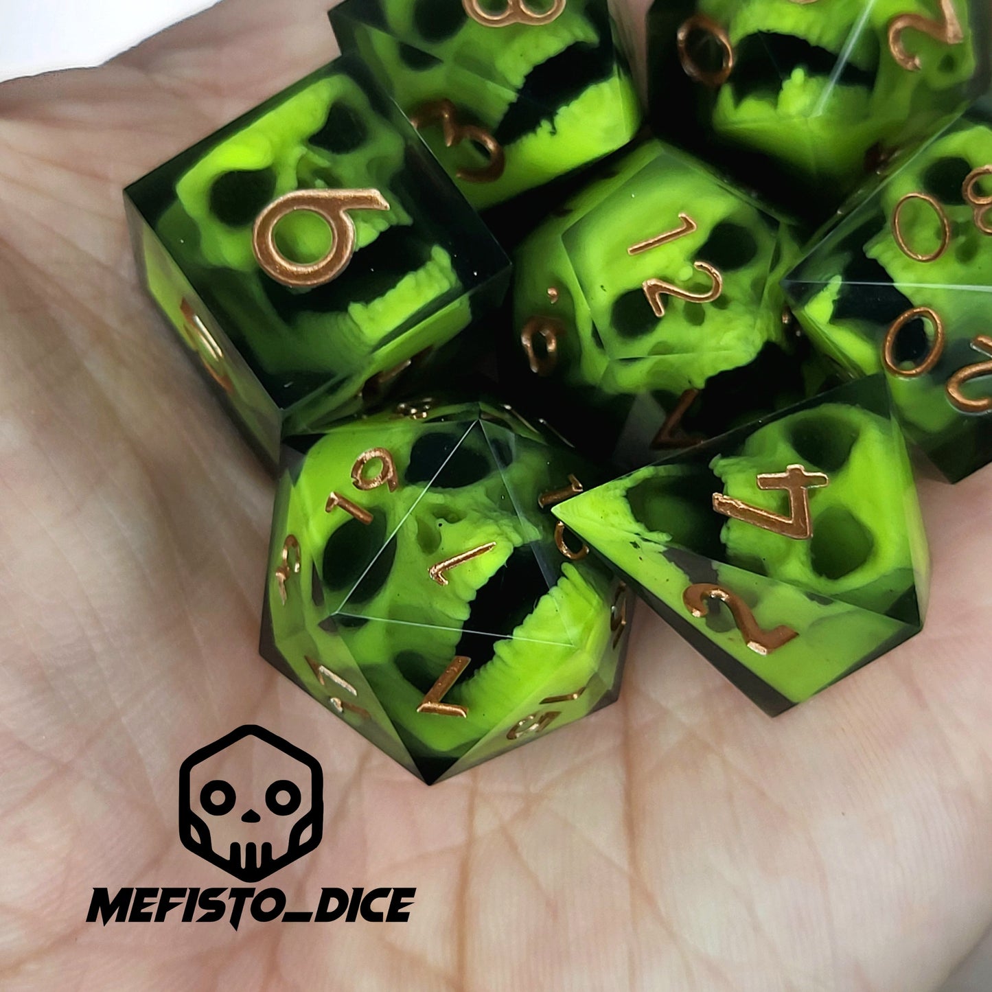 Black resin dice set featuring neon green undead skulls and metallic bronze numbers, handcrafted RPG dice for DnD and tabletop fantasy games