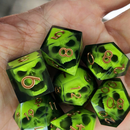Black resin dice set featuring neon green undead skulls and metallic bronze numbers, handcrafted RPG dice for DnD and tabletop fantasy games