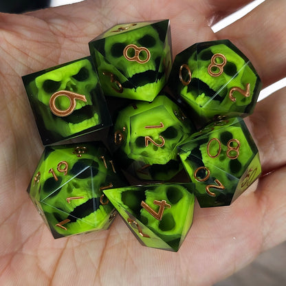 Black resin dice set featuring neon green undead skulls and metallic bronze numbers, handcrafted RPG dice for DnD and tabletop fantasy games