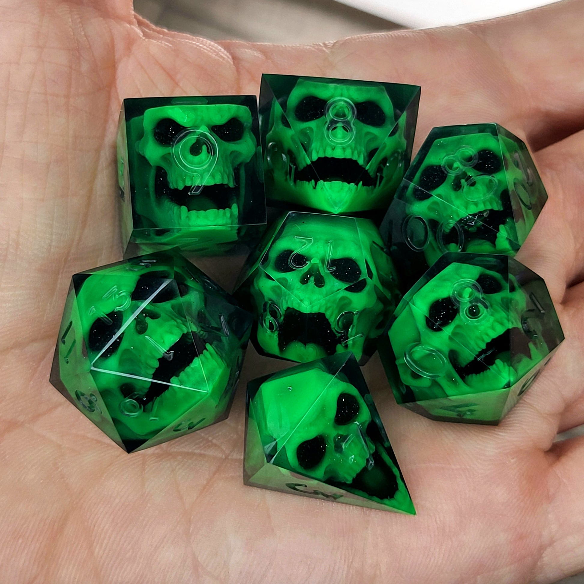 Black resin DnD dice set with bright green zombie skulls inside