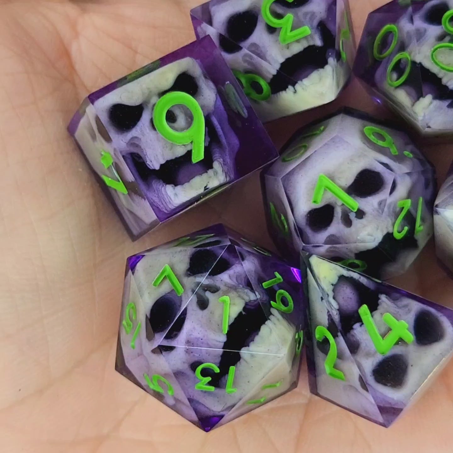 Purple resin DnD dice set with bone-colored zombie skulls inside and bright green numbers