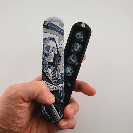 Close-up of a dice box featuring a detailed skeleton reaper illustration in shades of grey and blue, designed for storing RPG dice, handcrafted by Mefisto_Dice.