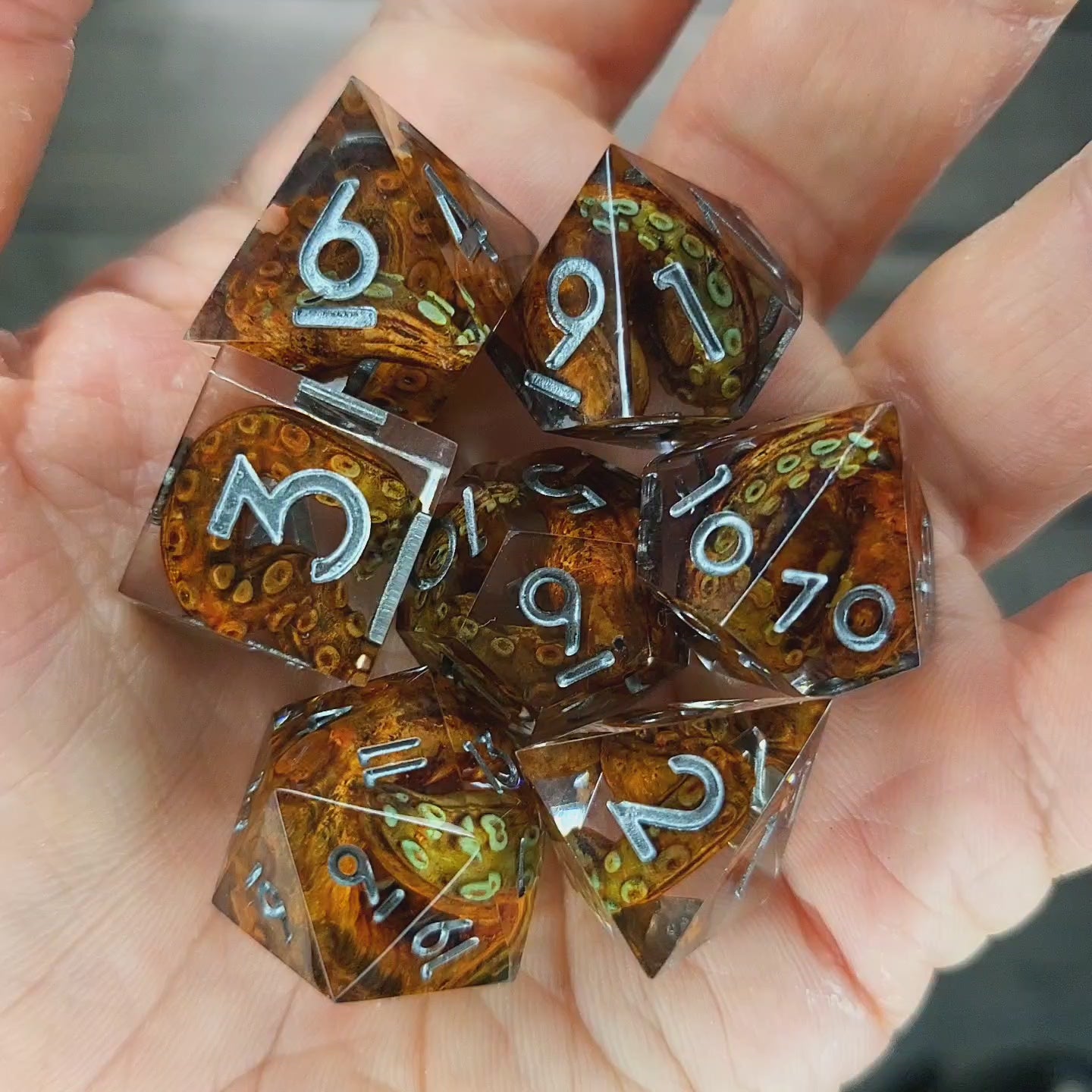 Dice set with brown tentacles inside and silver numbers for play dnd , dungeons and dragons